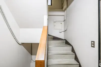 a staircase in a room with a stair case at Fuukanto Kinshicho BNB in Tokyo