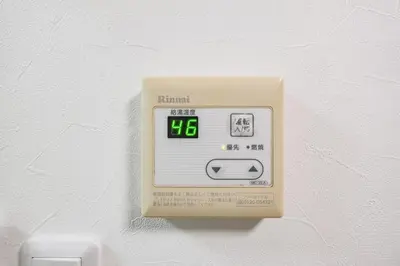 an electronic clock on a wall with a numeral on it at Fuukanto Kinshicho BNB in Tokyo