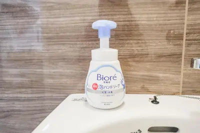 a bottle of cleaner sitting on top of a white sink at Fuukanto Kinshicho BNB in Tokyo