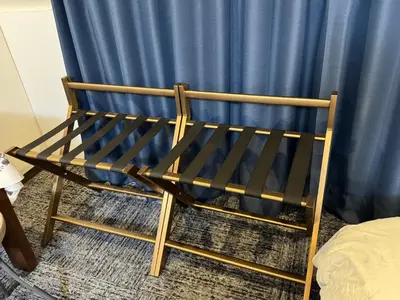 a wooden chair sitting in front of a blue curtain at Shiba inn in Tokyo