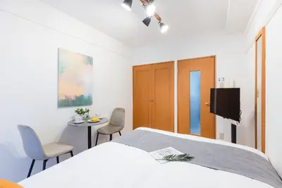 a bedroom with a bed and a table and chairs at Access\u6587\u4eac\u5927\u585a in Tokyo