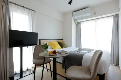 a bedroom with a bed and a table and a tv at Access\u6587\u4eac\u5927\u585a in Tokyo