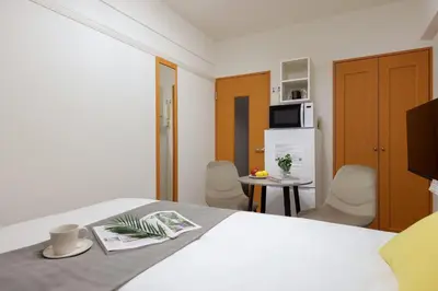 a hotel room with a bed and a table and chairs at Access\u6587\u4eac\u5927\u585a in Tokyo
