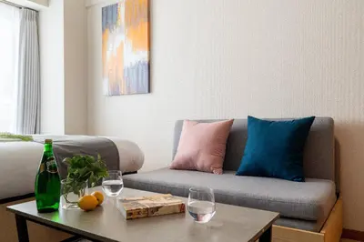 a living room with a couch and a table with wine glasses at Access\u6587\u4eac\u5927\u585a in Tokyo