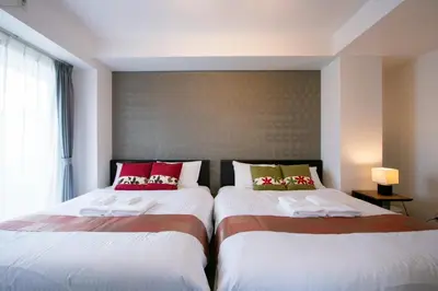 two beds sitting next to each other in a bedroom at Randor Residence Tokyo Annex in Tokyo