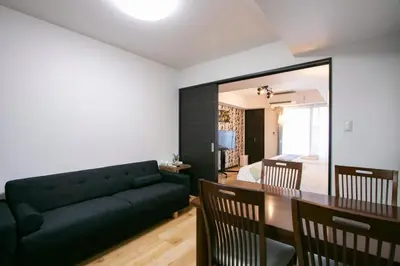 a living room with a couch and a dining room at Randor Residence Tokyo Annex in Tokyo