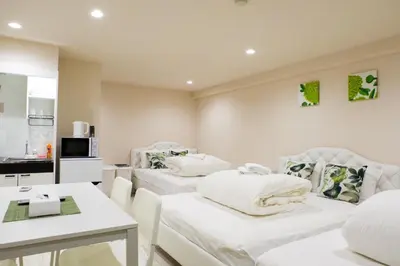 a room with two white beds and a table at Avinity Higashi Nakano 1F - Vacation STAY 87308v in Tokyo