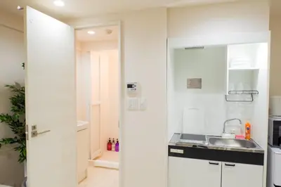 a kitchen with white cabinets and a sink at Avinity Higashi Nakano 1F - Vacation STAY 87308v in Tokyo