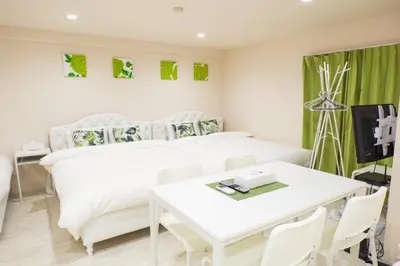 a white bedroom with a white bed and a table at Avinity Higashi Nakano 1F - Vacation STAY 87308v in Tokyo