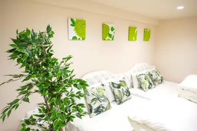 a bedroom with a white bed and a green plant at Avinity Higashi Nakano 1F - Vacation STAY 87308v in Tokyo