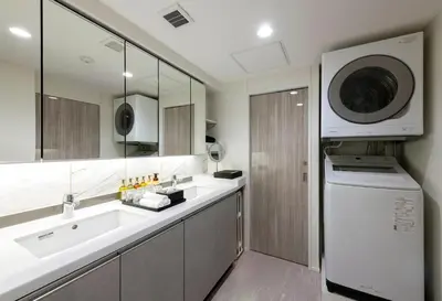 a bathroom with a sink and a washing machine at ENT TERRACE GINZA Premium in Tokyo