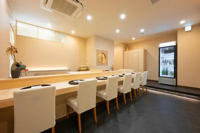 a dining room with a long table and white chairs at ENT TERRACE GINZA Premium in Tokyo
