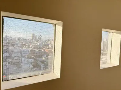 a window in a room with a view of a city at Shinjuku Kabuki Youth Hostel#New Sunshine Room#50 second walk from Higashi Shinjuku subway#Automatic locking door at entrance#\u65b0\u5bbf1 in Tokyo