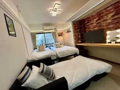 a small room with two beds and a window at Cozy Residential Retreat! Easy Access to Ikebukuro & Shinjuku in Tokyo