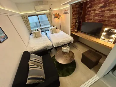a small room with two beds and a couch at Cozy Residential Retreat! Easy Access to Ikebukuro & Shinjuku in Tokyo