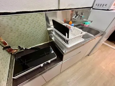 a kitchen counter with a sink and a dishwasher at Cozy Residential Retreat! Easy Access to Ikebukuro & Shinjuku in Tokyo
