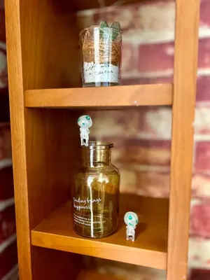 a shelf with a jar and tiny figurines on it at Cozy Residential Retreat! Easy Access to Ikebukuro & Shinjuku in Tokyo