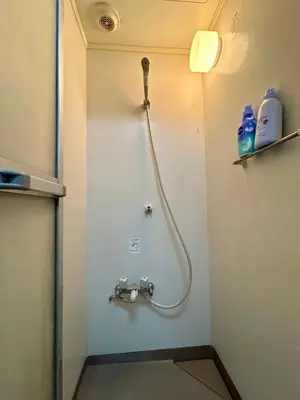 a shower in a bathroom with a hose on the wall at Cozy Residential Retreat! Easy Access to Ikebukuro & Shinjuku in Tokyo