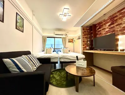 a living room with two beds and a couch at Cozy Residential Retreat! Easy Access to Ikebukuro & Shinjuku in Tokyo