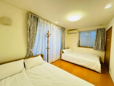 a small room with two beds and a window at PUSU-OKUBO House 3LDK-SJ0079 in Tokyo