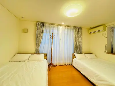 two beds in a room with a window at PUSU-OKUBO House 3LDK-SJ0079 in Tokyo