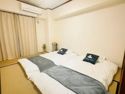 two beds in a room with white walls at Ikebukuro\u4e2d\u5ddd5E -TS0036 in Tokyo