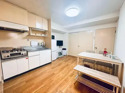a kitchen with white cabinets and a wooden floor at Ikebukuro\u4e2d\u5ddd5E -TS0036 in Tokyo