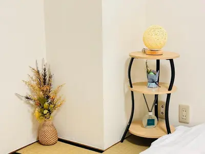 a room with two shelves with flowers and a vase at Ikebukuro\u4e2d\u5ddd5E -TS0036 in Tokyo