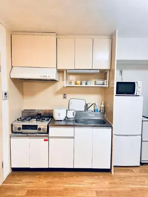 a small kitchen with white cabinets and a sink at Ikebukuro\u4e2d\u5ddd5E -TS0036 in Tokyo