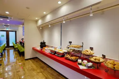 a buffet line with bread and pastries on display at HOTEL Guest1 Ueno Ekimae in Tokyo
