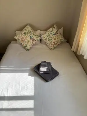 a purse sitting on top of a white bed at Shinjuku\u5bbf in Tokyo