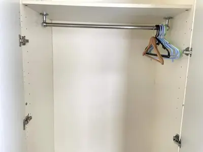 a shower door with a hanger and a hanger at Shinjuku\u5bbf in Tokyo
