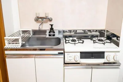 a kitchen with a sink and a stove at Za086 \u67cf\u539f\u30d3\u30eb101 in Tokyo