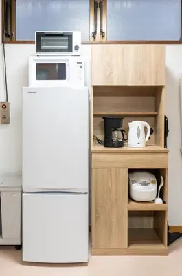 a white refrigerator with a microwave on top of it at Za086 \u67cf\u539f\u30d3\u30eb101 in Tokyo
