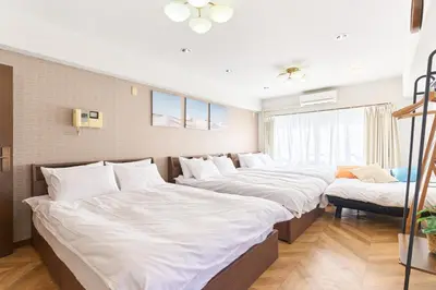 a row of beds in a room at B-Shinjuku luxury house with EV Max12P in Tokyo