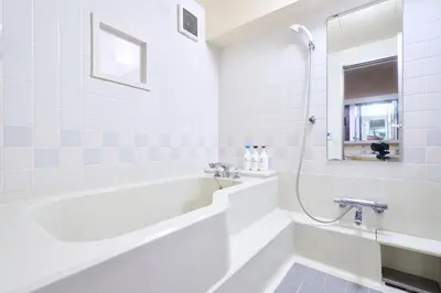 a white bathroom with a tub and a shower at B-Shinjuku luxury house with EV Max12P in Tokyo