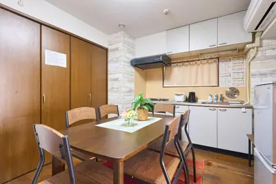 a kitchen and dining room with a wooden table and chairs at B-Shinjuku luxury house with EV Max12P in Tokyo