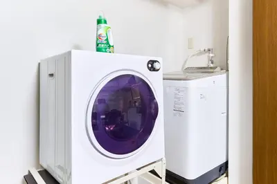a washing machine with a bottle on top of it at B-Shinjuku luxury house with EV Max12P in Tokyo