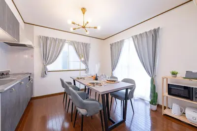 a kitchen with a dining room table and chairs at Vivere in Tokyo