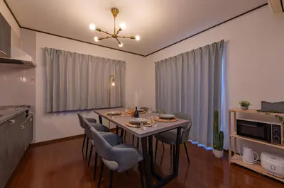 a living room with a dining room table with chairs at Vivere in Tokyo