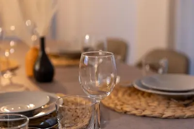 a table with wine glasses and plates on it at Vivere in Tokyo