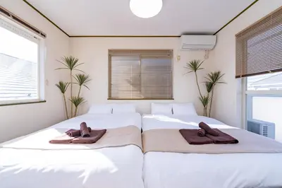 two beds in a bedroom with towels on them at Vivere in Tokyo