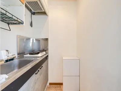 a kitchen with a sink and a refrigerator at Omotesando Sta 8min walk,Shibuya,Harajuku 3min,10GB net, PocketWiFi, Switch in Tokyo