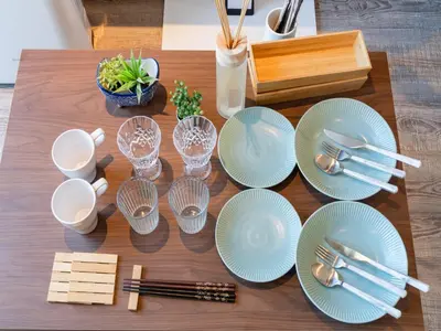 a table with blue plates and silverware on it at Omotesando Sta 8min walk,Shibuya,Harajuku 3min,10GB net, PocketWiFi, Switch in Tokyo