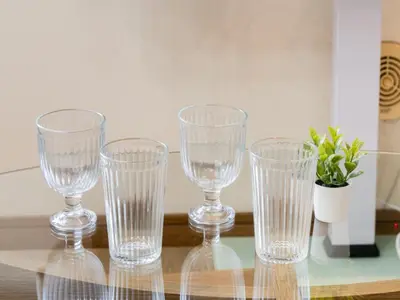 four empty wine glasses sitting on a glass table at Omotesando Sta 8min walk,Shibuya,Harajuku 3min,10GB net, PocketWiFi, Switch in Tokyo