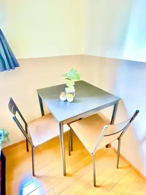 a blue table with two chairs and a plant on it at Vonveil Shibuya in Tokyo