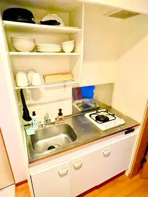 a small kitchen with a sink and a stove at Vonveil Shibuya in Tokyo