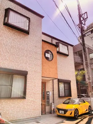 a yellow car parked in front of a building at Vonveil Shibuya in Tokyo