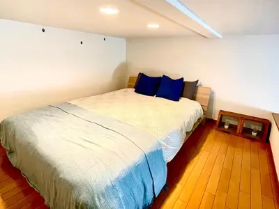 a bedroom with a large bed with blue pillows at Vonveil Shibuya in Tokyo