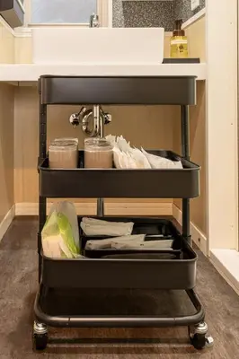 a kitchen cart filled with dishes and utensils at NEXUS HOTEL Gotanda WEST in Tokyo